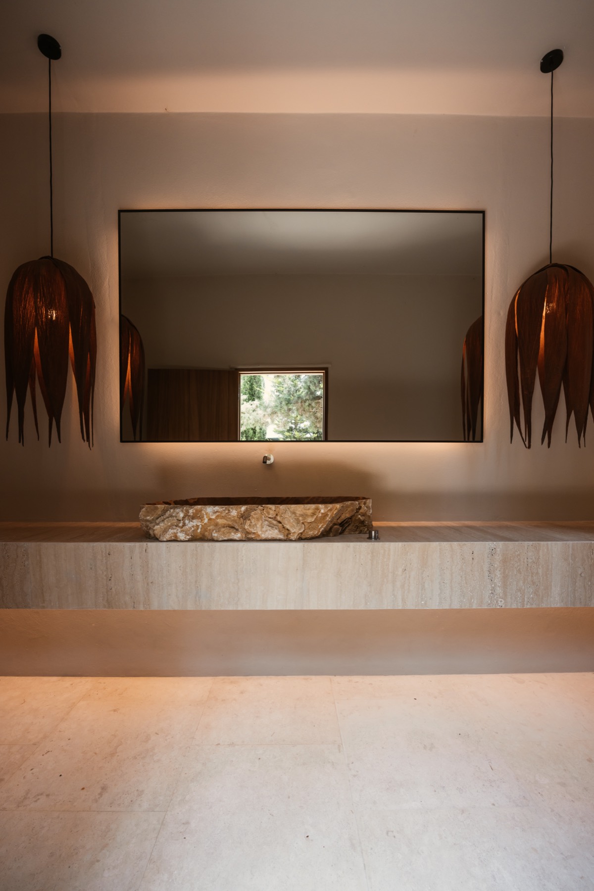 Natural stone, bespoke lighting and warm architectural detailing