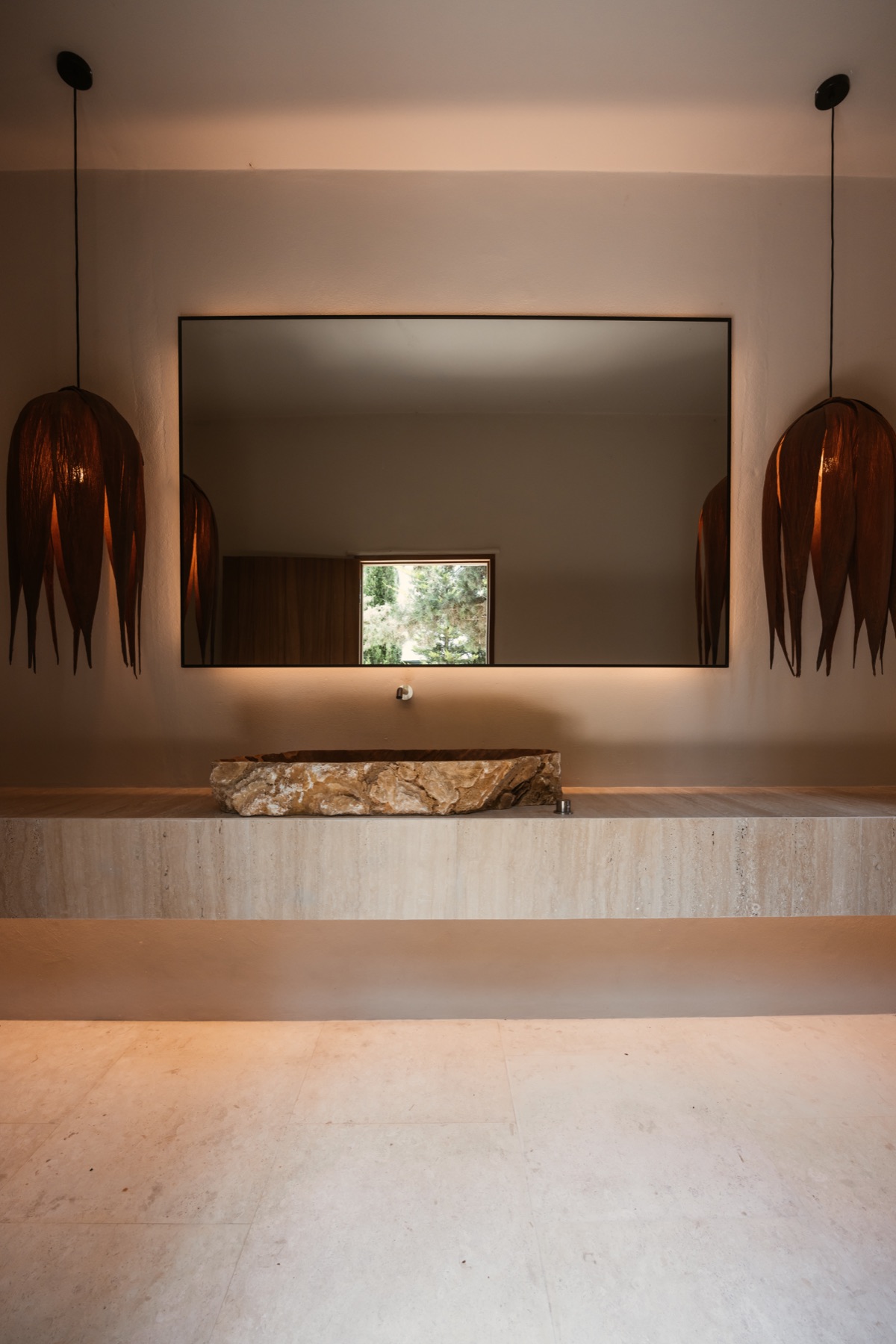 Sculptural stone basin and bespoke lighting